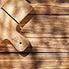 Empty board with fork and knife on wooden table. Top view