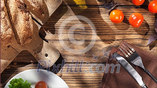 Top view of italian food on wooden table - bread, olive oil and tomatos with basil. Header for website Top view of italian food on wooden table - bread, olive oil and tomatos with basil. Header for website