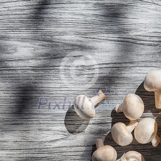 Mushrooms on wooden table, top view image
