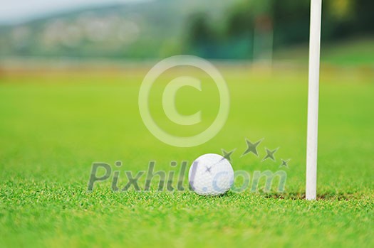 golf ball on sports golf course and hole golf ball on sports golf course and hole