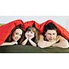 happy young family relaxing in bed 