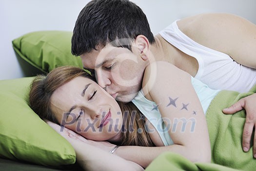 happy young couple in bed at morning happy young couple in bed at morning
