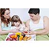 happy young family eat breakfast in bed at morning 