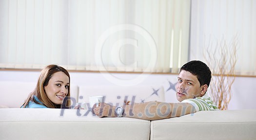 happy young couple relax at home in modern and bright living room happy young couple relax at home in modern and bright living room