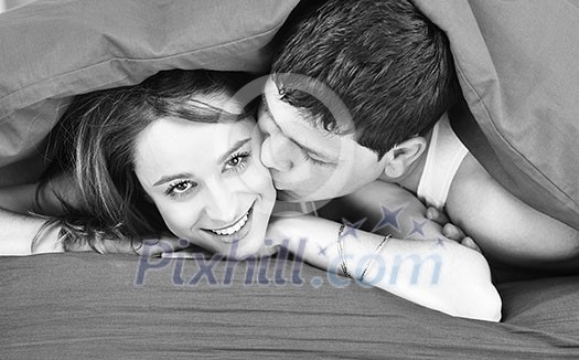 happy young couple in bed at morning happy young couple in bed at morning