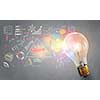 Glass glowing light bulb and business sketched ideas