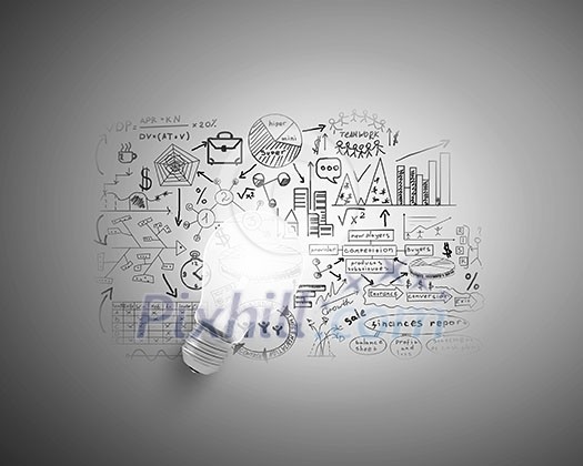 Glass glowing light bulb and business sketched ideas Glass glowing light bulb and business sketched ideas