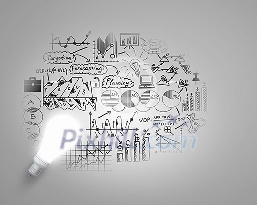 Glass glowing light bulb and business sketched ideas Glass glowing light bulb and business sketched ideas