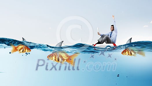 Concept of fake threat when businessman float in lifebuoy and sharks in water appear to be goldfish Concept of fake threat when businessman float in lifebuoy and sharks in water appear to be goldfish