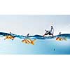 Concept of fake threat when businessman float in lifebuoy and sharks in water appear to be goldfish