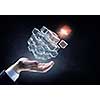 Businessman hand shows cube as symbol of problem solving