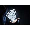 Businesswoman hand shows cube as symbol of problem solving