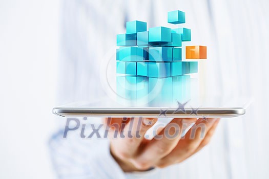 Businessman holding tablet and cube as symbol of problem solving Businessman holding tablet and cube as symbol of problem solving
