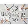 Top view of people hands drawing business teamwork strategy