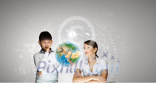 Woman teacher and boy at lesson touching media screen. Elements of this image are furnished by NASA Woman teacher and boy at lesson touching media screen. Elements of this image are furnished by NASA
