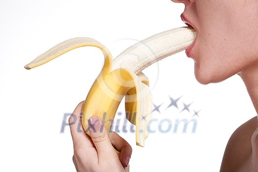 Young woman biting banana isolated on white Young woman biting banana isolated on white