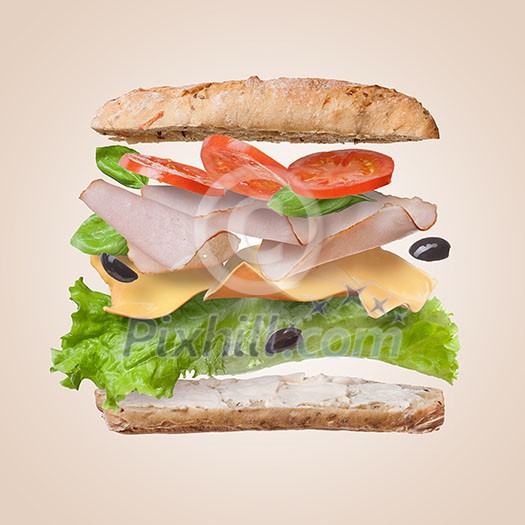 Sandwich with falling ingredients in the air - slices of fresh tomatoes, ham, cheese and lettuce Sandwich with falling ingredients in the air - slices of fresh tomatoes, ham, cheese and lettuce
