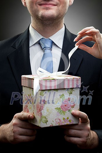 closeup portrait of businessman holding gift with woman hand closeup portrait of businessman holding gift with woman hand