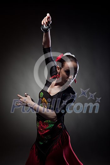 young woman dancing flamenco with castanets on black young woman dancing flamenco with castanets on black