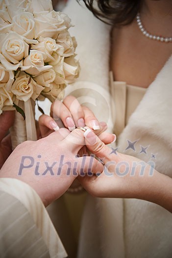 puttting on a wedding ring. natural photo puttting on a wedding ring. natural photo
