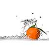 Tangerine with green leaves and water splash isolated on white