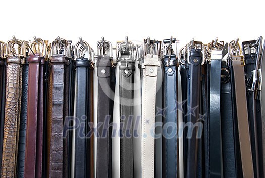 a lot of leather belts in store isolated on white a lot of leather belts in store isolated on white