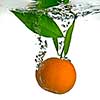 tangerine dropped into water with bubbles on white