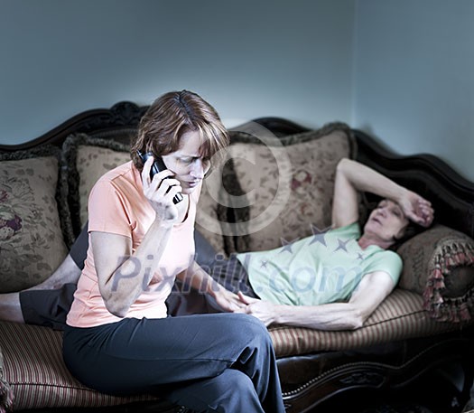 Concerned woman with sick senior mother calling emergency Concerned woman with sick senior mother calling emergency