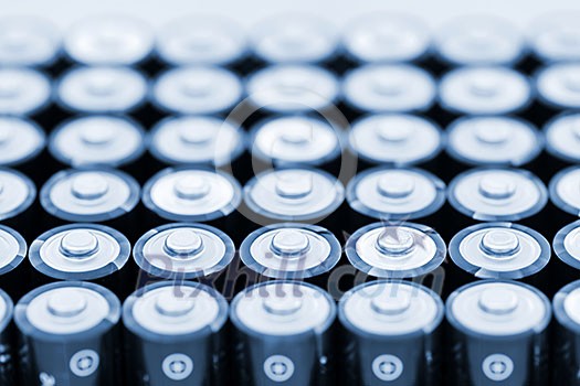 Tops of many AA batteries in closeup Tops of many AA batteries in closeup