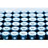 Tops of many AA batteries in closeup