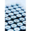 Tops of many AA batteries in closeup