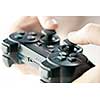 Male hands holding video game controller closeup