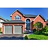 Brick house in suburbs with two car garage