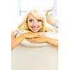 Portrait of smiling happy blonde woman relaxing on couch at home