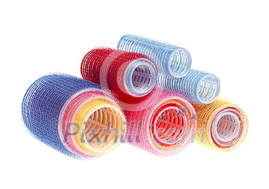 Colorful hair rollers stacked isolated on white background Colorful hair rollers stacked isolated on white background