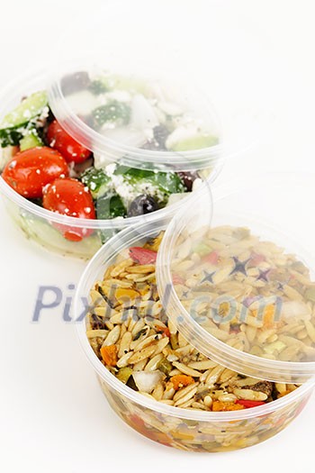 Two servings of prepared salad in plastic takeaway containers Two servings of prepared salad in plastic takeaway containers