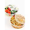 Two servings of prepared salad in plastic takeaway containers