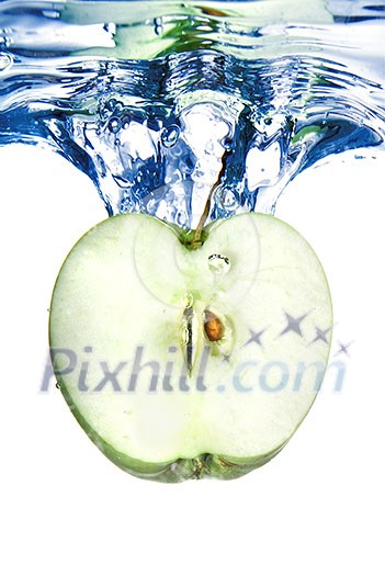 green apple dropped into blue water with splash isolated on white green apple dropped into blue water with splash isolated on white