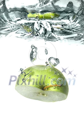 green apple dropped into water with splash isolated on white green apple dropped into water with splash isolated on white