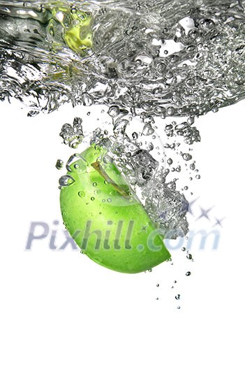 green apple dropped into water isolated on white green apple dropped into water isolated on white