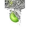green apple dropped into water isolated on white