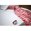 close-up photo of stud on white shirt with red tie