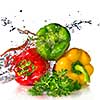 red, yellow, green pepper and parsley with water splash isolated on white