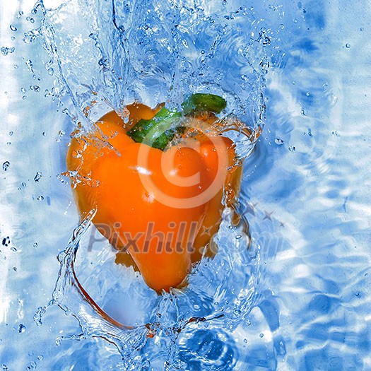 Yellow pepper dropped into water with bubbles Yellow pepper dropped into water with bubbles