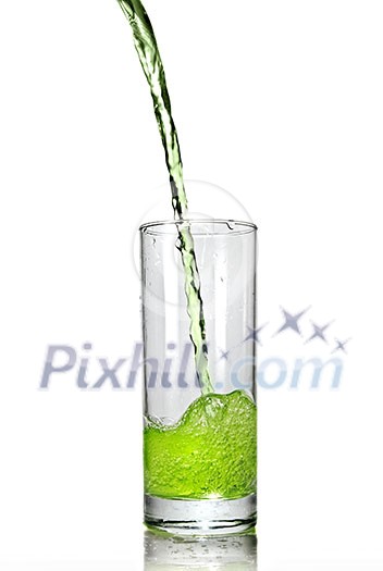 green juice pouring into glass isolated on white green juice pouring into glass isolated on white