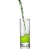 green juice pouring into glass isolated on white