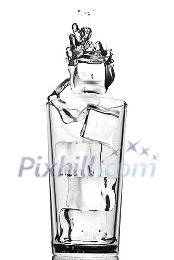 ice cubes dropped into glass with bubbles isolated on white ice cubes dropped into glass with bubbles isolated on white