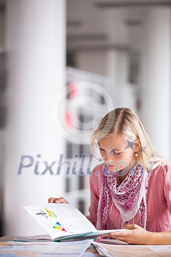 in the library - pretty female student with books working in a high school library (color toned image) in the library - pretty female student with books working in a high school library (color toned image)