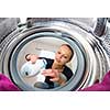 Housework: young woman doing laundry (shallow DOF; color toned image)