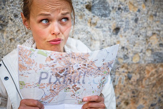 Gorgeous female tourist with a map discovering a foreign city (shallow DOF; color toned image) Gorgeous female tourist with a map discovering a foreign city (shallow DOF; color toned image)